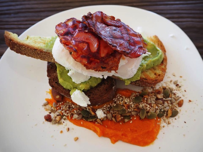 A house specialty - the toasted dark rye and pumpkin bread, smashed avocado, danish feta, pumpkin hummus, crispy pancetta and dukka. We added poached eggs to the heavenly dish!