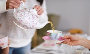 teapot pouring tea into cup