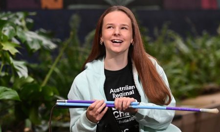 South Australian student Shianne Durdin smiles while holding a purple and blue cane ahead of becoming Australia’s first International Braille Challenge finalist.