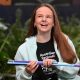 South Australian student Shianne Durdin smiles while holding a purple and blue cane ahead of becoming Australia’s first International Braille Challenge finalist.