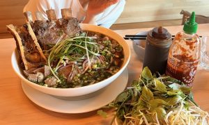 A giant bowl of pho and its condiments