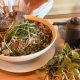 A giant bowl of pho and its condiments