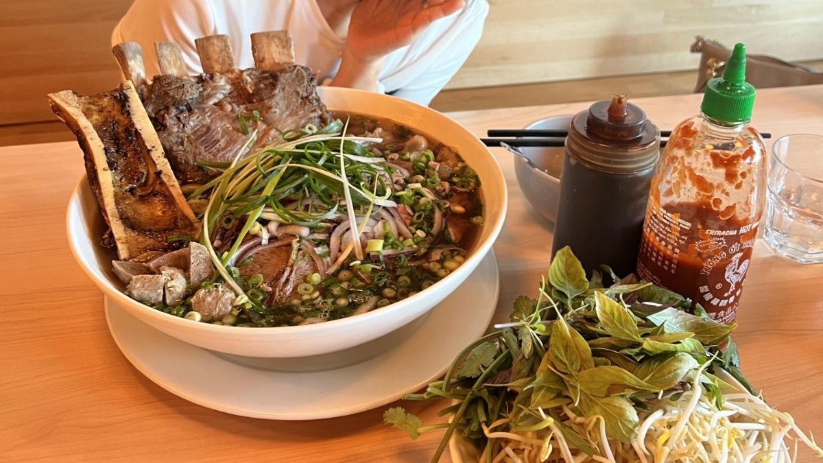 A giant bowl of pho and its condiments