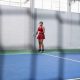 Young woman playing pickleball, holding paddle and getting ready to serve