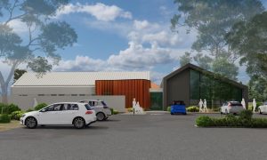 Render of the new eating disorder centre, a low building with timber and dark cladding and a gabled glass front, with cars parked out the front